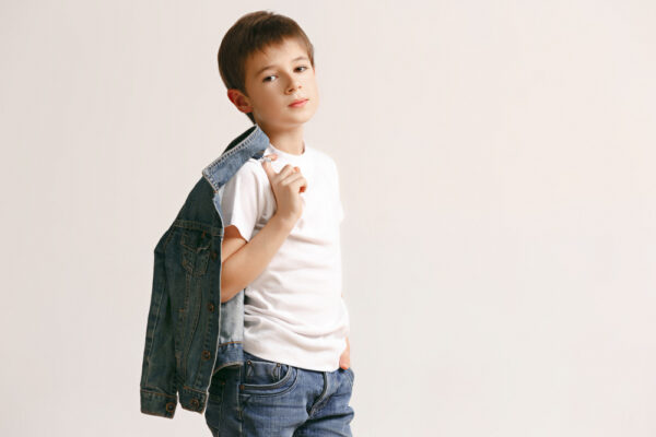 portrait cute little kid boy stylish jeans clothes looking camera against white studio wall kids fashion concept